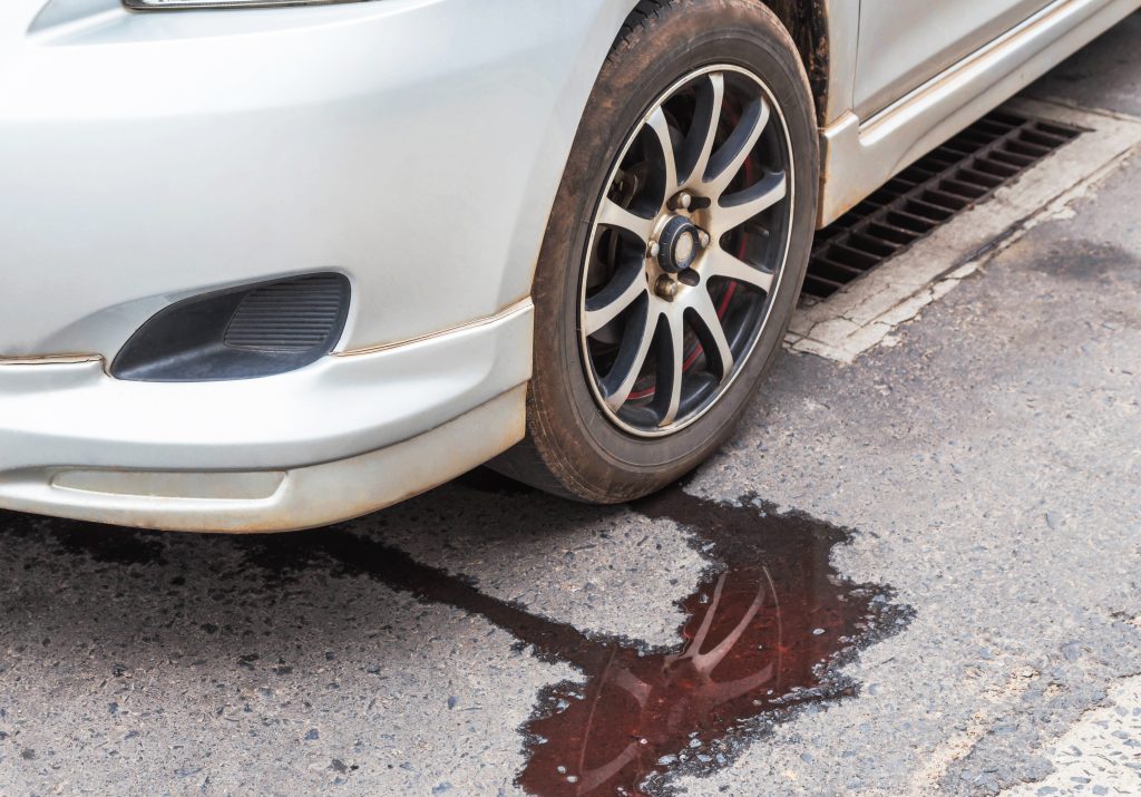 An image of a car leaking transmission fluid. 