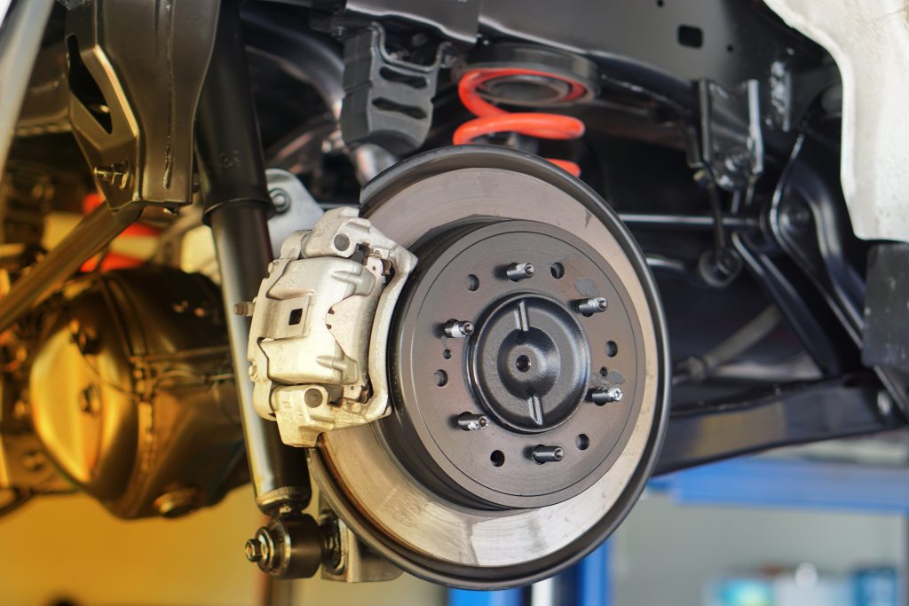 An image of new brakes applied to a car before the wheel is put back on.