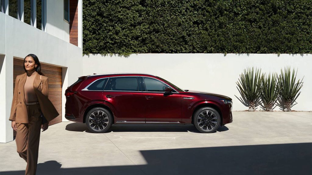 Exterior passenger side of a red 2026 Mazda CX-90 parked in a driveway in Shiloh, IL