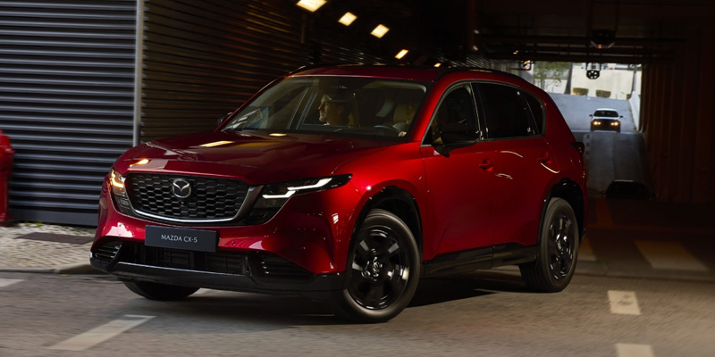 Red 2026 Mazda CX-5 driving safely through a tunnel